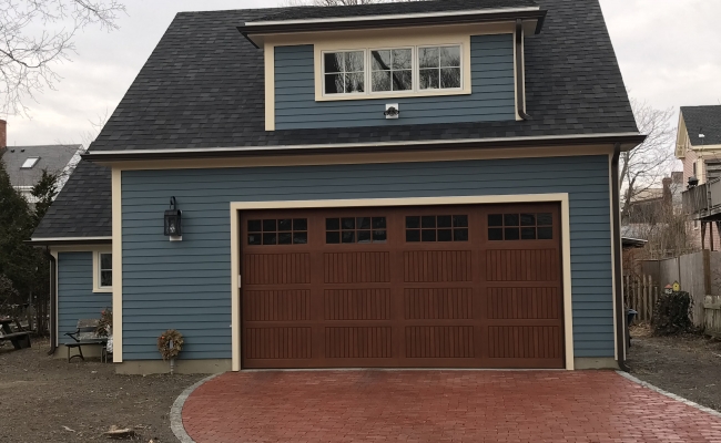 blue house with brown garage door