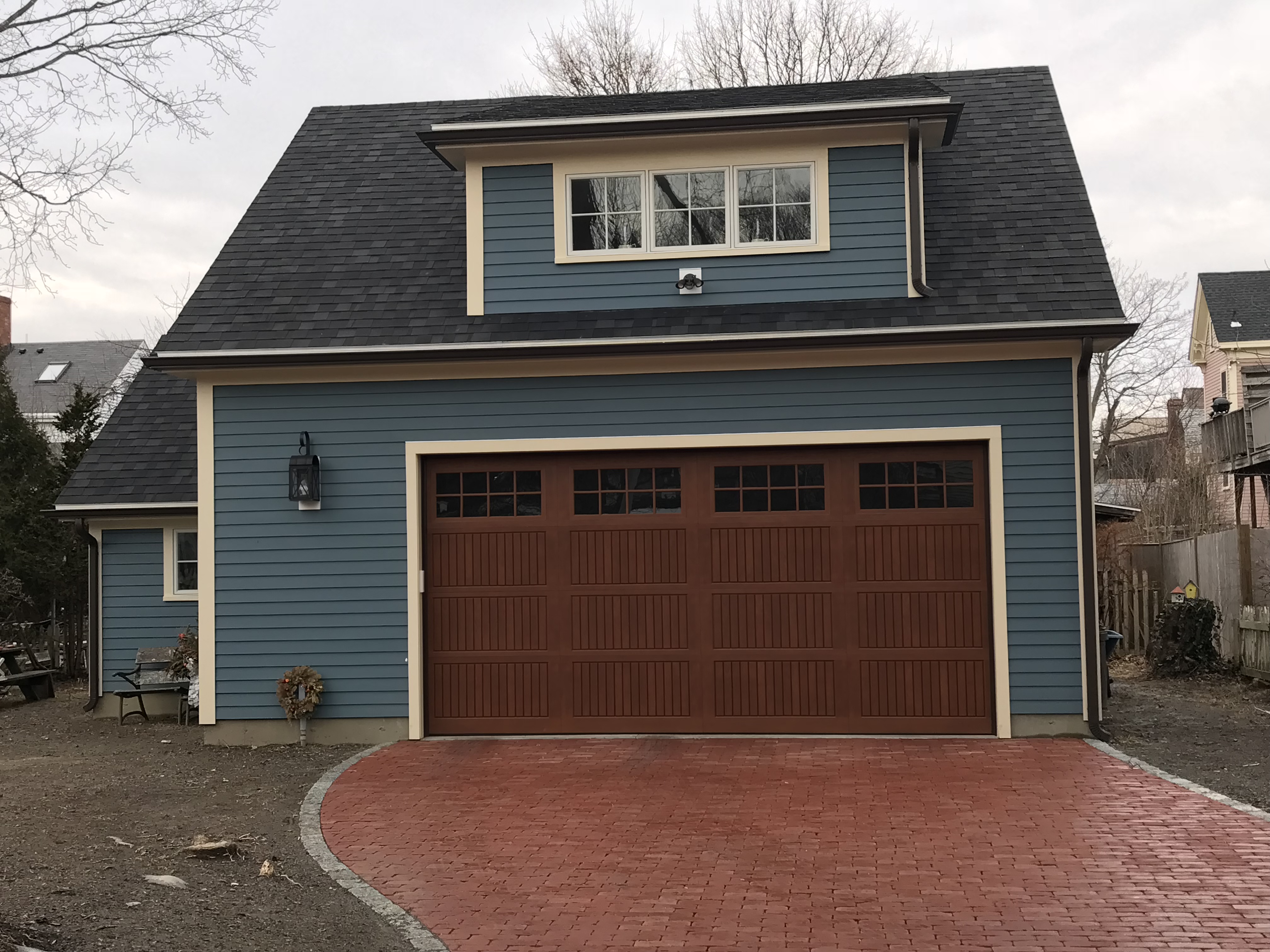 blue house with brown garage door