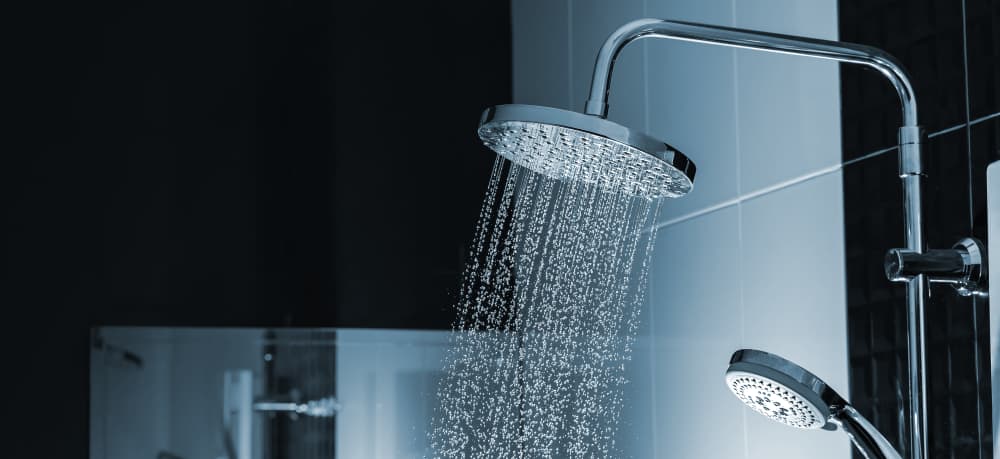 Water streaming out of a modern shower head