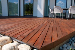wooden deck in a backyard of a home with sealant on top to protect the wood and color from fading in the uv rays
