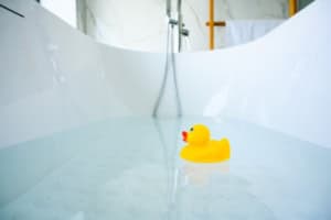 rubber duck floating in a bathtub soaking tub instead of a jetted whirlpool tub